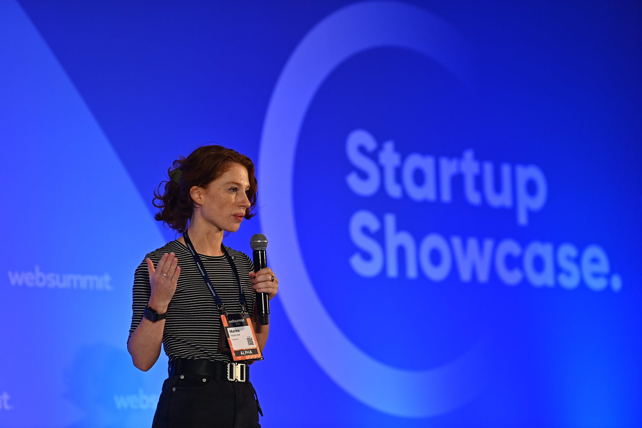Marina Naperstak, CEO of imgproxy, holding a microphone and assumedly speaking at Startup Showcase Stage during Web Summit 2022.