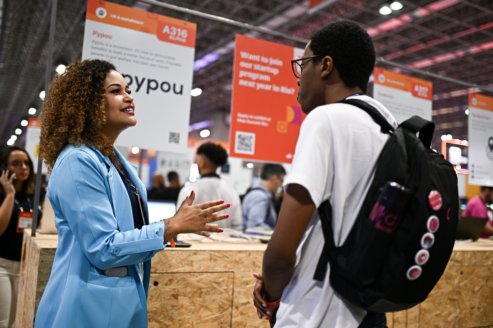 Attendees at Info Point during day one of Web Summit Rio 2023 at Riocentro in Rio de Janeiro, Brazil